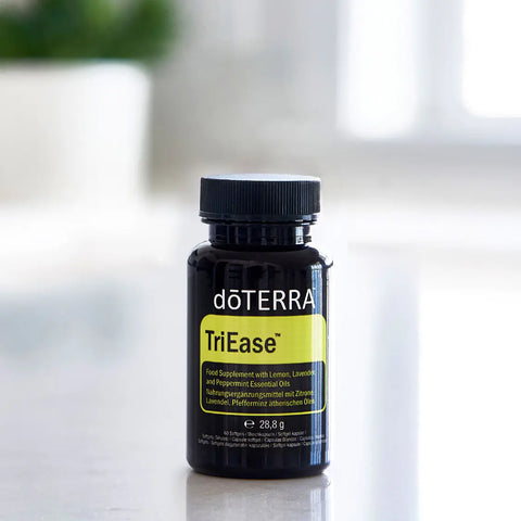 dōTERRA TriEase Nahrungsergänzung 60ct Flasche auf schwarzer Theke mit Pflanze | doTERRA