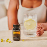 dōTERRA Zendocrine Softgels schwarze Flasche mit Softgels, Gefäß und Zitrone auf der Theke | doTERRA