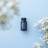 dōTERRA ZenGest Softgels Flasche mit weißen Blumen vor blauem Hintergrund von oben | doTERRA