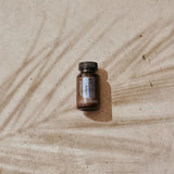 dōTERRA ZenGest Softgels Flasche auf Sand mit Palmenschatten von oben | doTERRA
